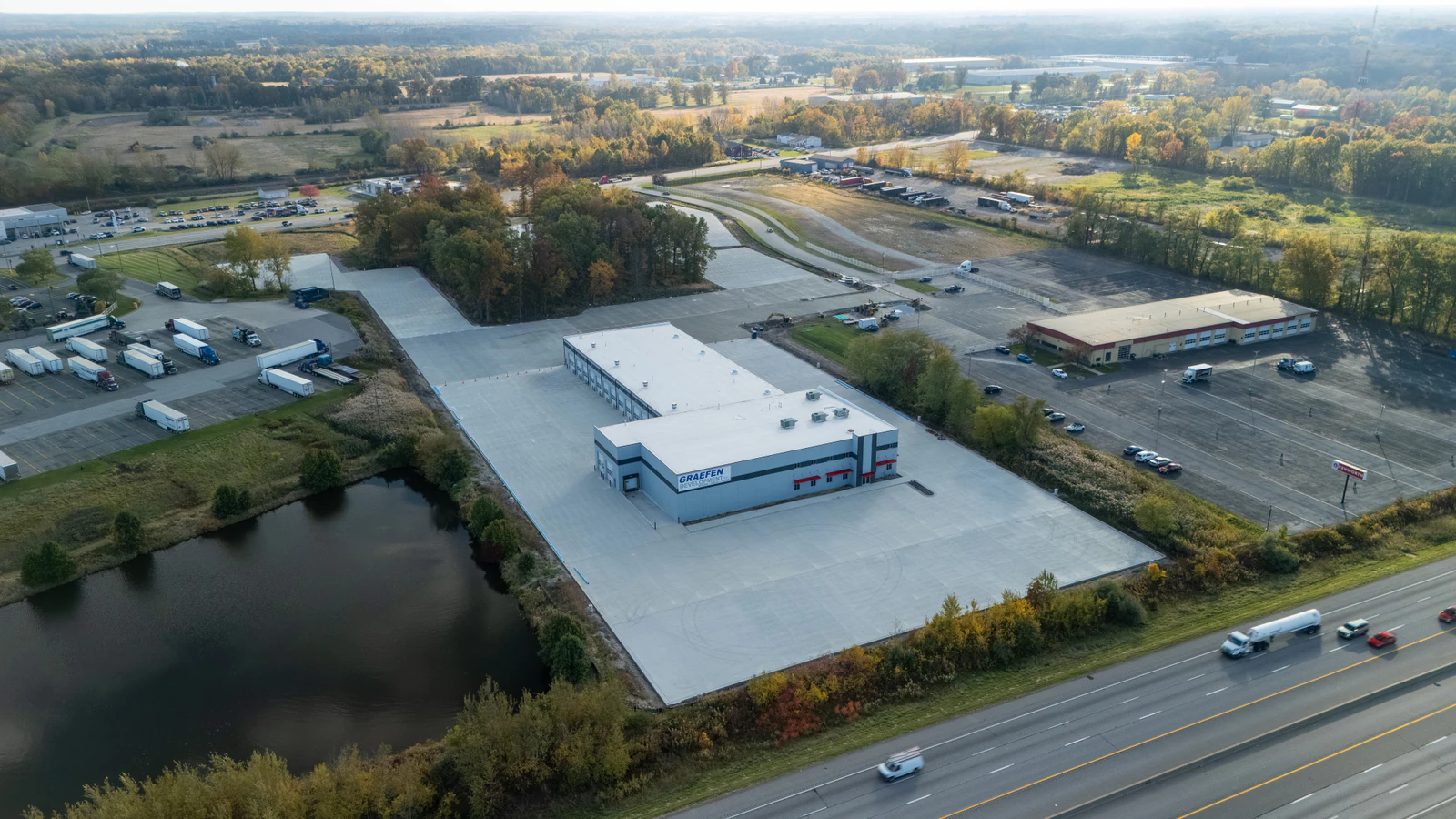 Aerial view of the completed concrete lot and sitework at the Rihm Kenworth truck dealership