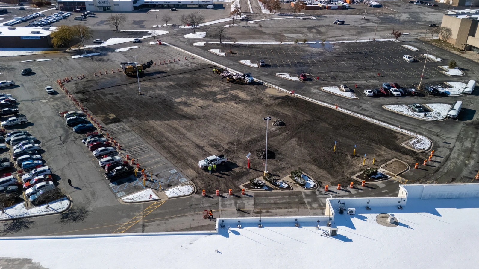 Aerial view of a commercial site during excavation and grading, with subgrade stripped and prepared for aggregate base