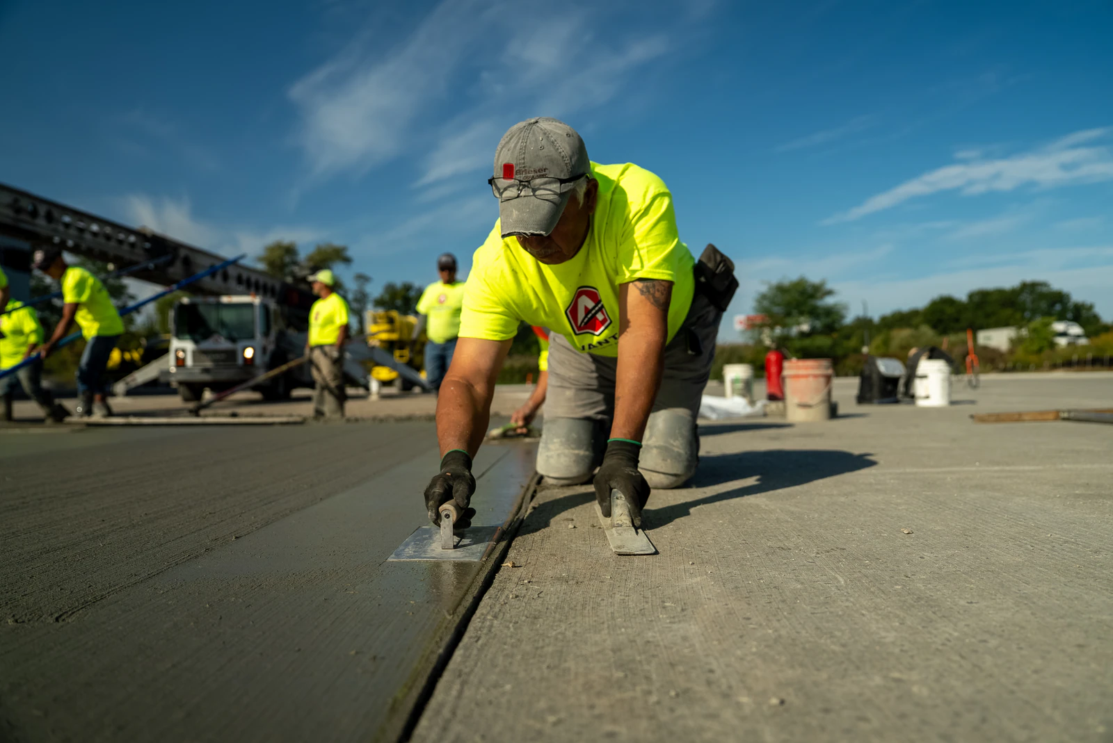 Advantage Paving crew member hand-finishing the edge of a fresh concrete slab